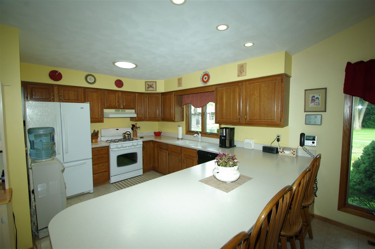 8638 Rote Road Rockford, IL 61107 - Photo 2 of 25 a kitchen with refrigerator cabinets and furniture