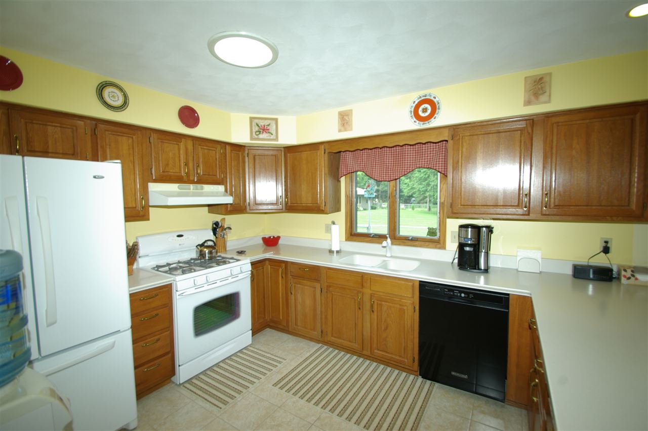 8638 Rote Road Rockford, IL 61107 - Photo 4 of 25 a kitchen with a sink a stove a refrigerator and black cabinets