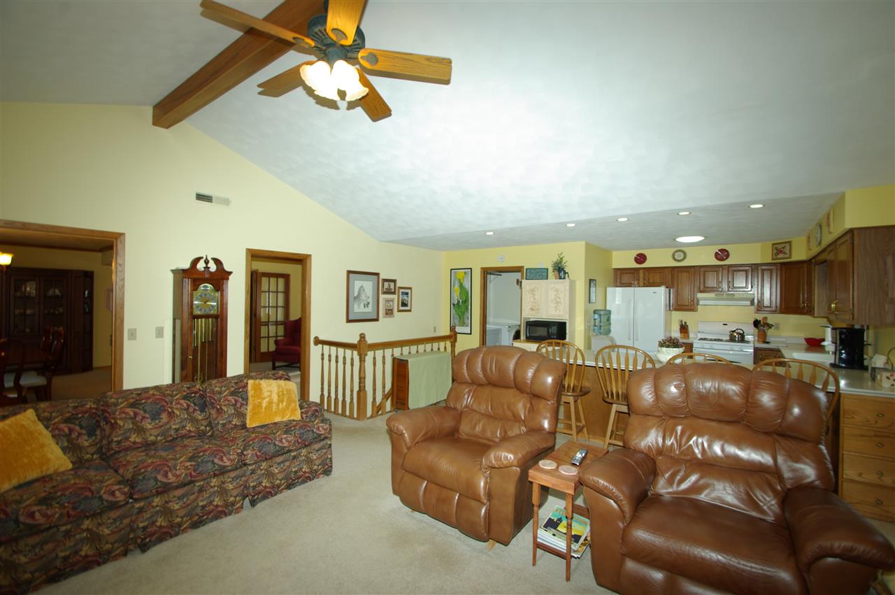 8638 Rote Road Rockford, IL 61107 - Photo 8 of 25 a living room with furniture and a chandelier