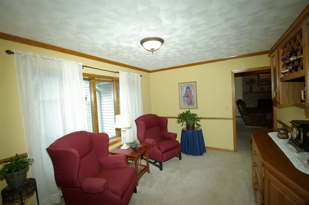 8638 Rote Road Rockford, IL 61107 - Photo 9 of 25 a living room with furniture rug and lamp