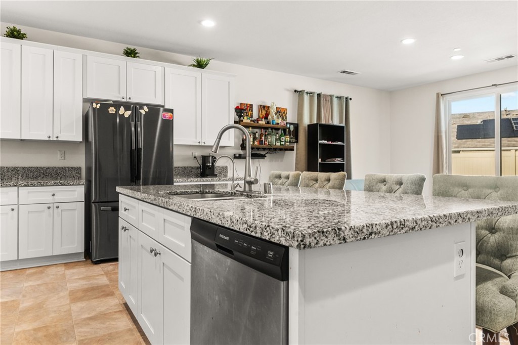 468 Bristolwood Road Hemet, CA 92543 - Photo 14 of 55 a kitchen with stainless steel appliances granite countertop a sink and a refrigerator