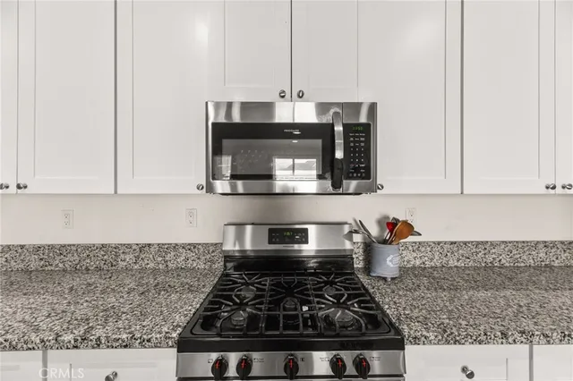 a living room with furniture a large window and flat screen tv
