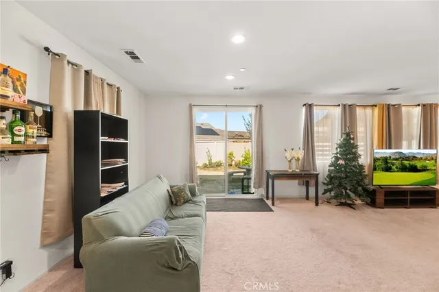 a living room with furniture and kitchen view