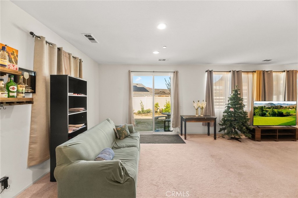 468 Bristolwood Road Hemet, CA 92543 - Photo 18 of 55 a living room with furniture a large window and flat screen tv