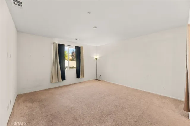 a bedroom with a large bed and a potted plant