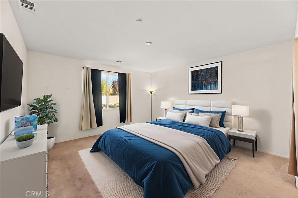 468 Bristolwood Road Hemet, CA 92543 - Photo 25 of 55 a bedroom with a large bed and a potted plant