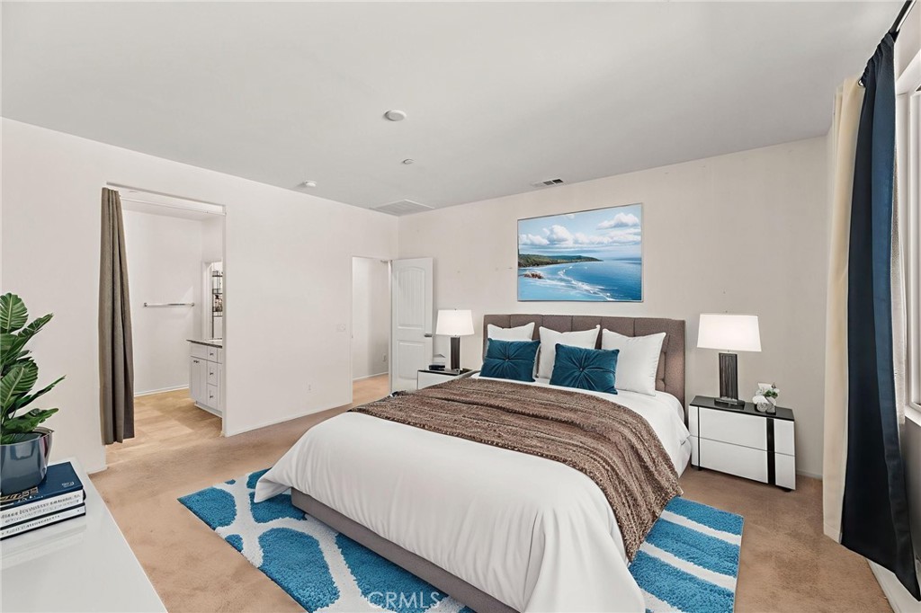 468 Bristolwood Road Hemet, CA 92543 - Photo 29 of 55 a spacious bedroom with a bed and a painting on the wall