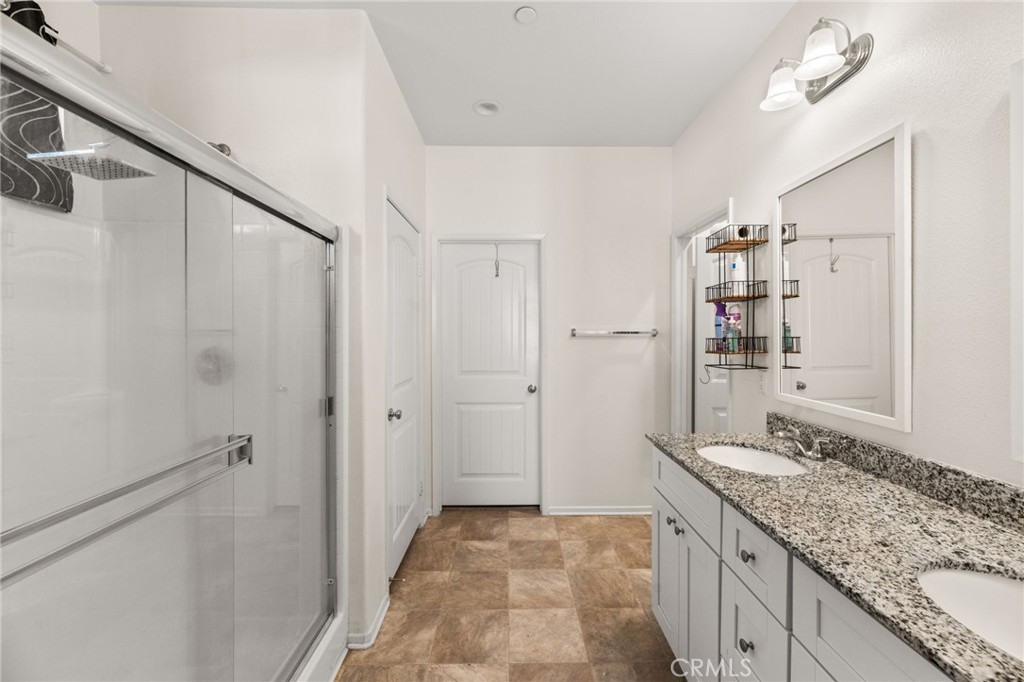 468 Bristolwood Road Hemet, CA 92543 - Photo 30 of 55 a bathroom with a granite countertop sink mirror and shower