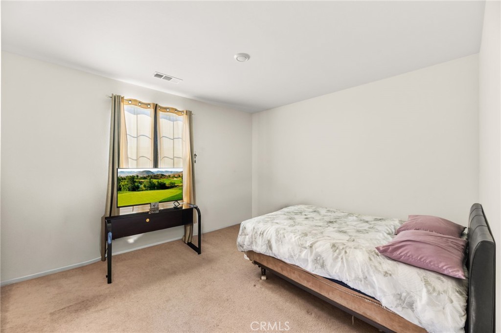 468 Bristolwood Road Hemet, CA 92543 - Photo 35 of 55 a bedroom with a bed a table and a window