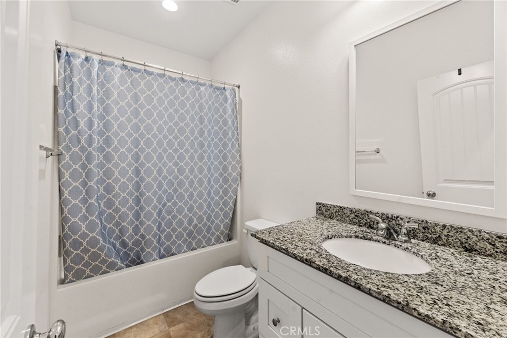 468 Bristolwood Road Hemet, CA 92543 - Photo 37 of 55 a bathroom with a granite countertop sink and a mirror