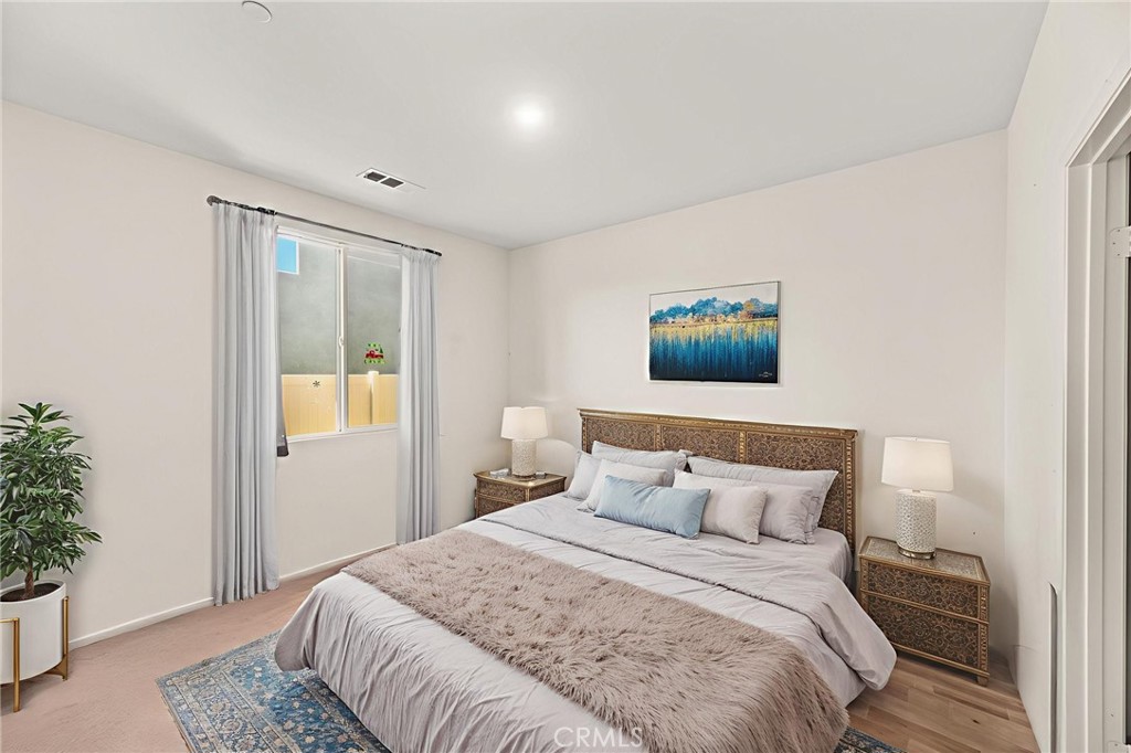 468 Bristolwood Road Hemet, CA 92543 - Photo 39 of 55 a bedroom with a bed and a potted plant