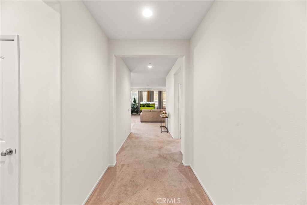 468 Bristolwood Road Hemet, CA 92543 - Photo 8 of 55 a view of a hallway with a livingroom and a bathroom with sink