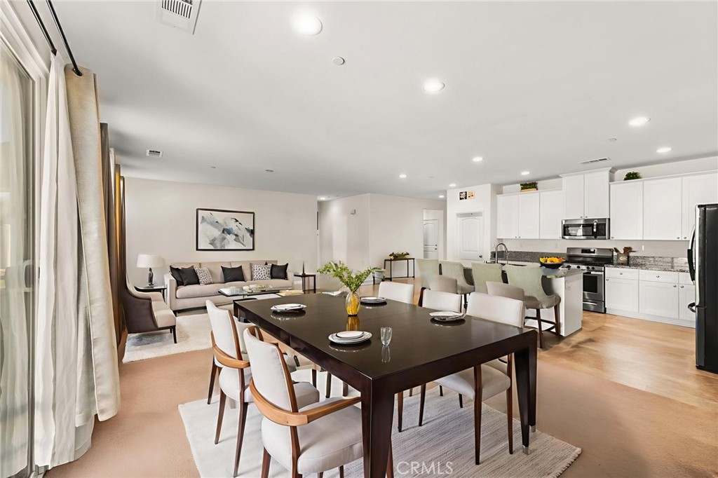 468 Bristolwood Road Hemet, CA 92543 - Photo 10 of 55 a view of a dining room with furniture and wooden floor