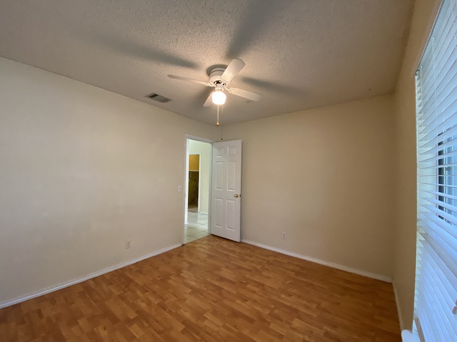 1903 Balsam Way Round Rock, TX 78665 - Photo 15 of 21 Well-lit bed room #1 with wood-look flooring and a bright window for ample natural light.
