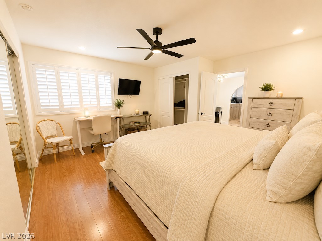 3010 East Viking Road Las Vegas, NV 89121 - Photo 29 of 48 Hardwood floors and bright windows enhance this comfortable primary bedroom, featuring a convenient ceiling fan.