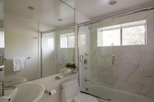 a bathroom with a shower a toilet and a shower