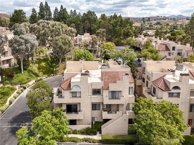 an aerial view of residential houses with outdoor space