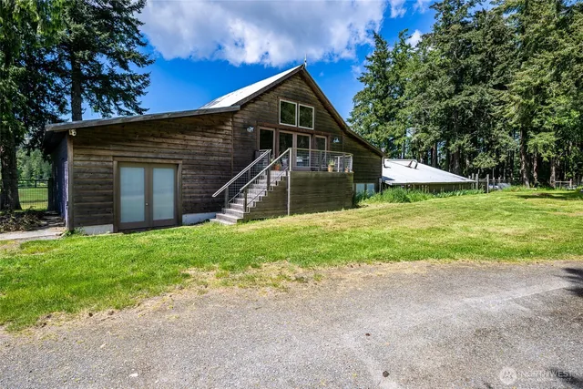 a view of a house with a yard and sitting area