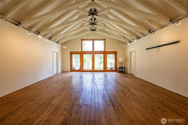 a big room with wooden floors and chandelier