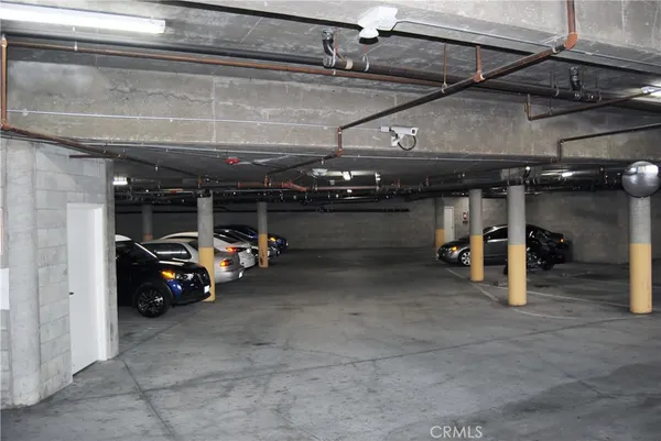 a view of parking garage with cars