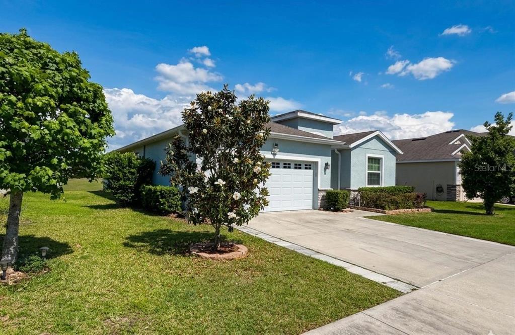 5703 Southwest 50th Avenue Ocala, FL 34474 - Photo 2 of 3 a front view of a house with a yard