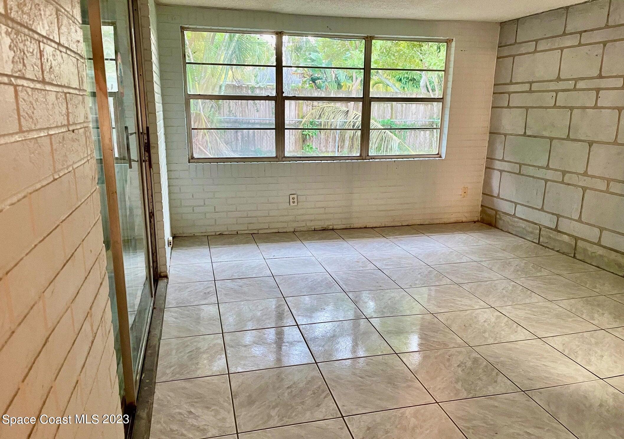245 Richards Road Melbourne Beach, FL 32951 - Photo 5 of 18 a view of a livingroom with an empty space and a window