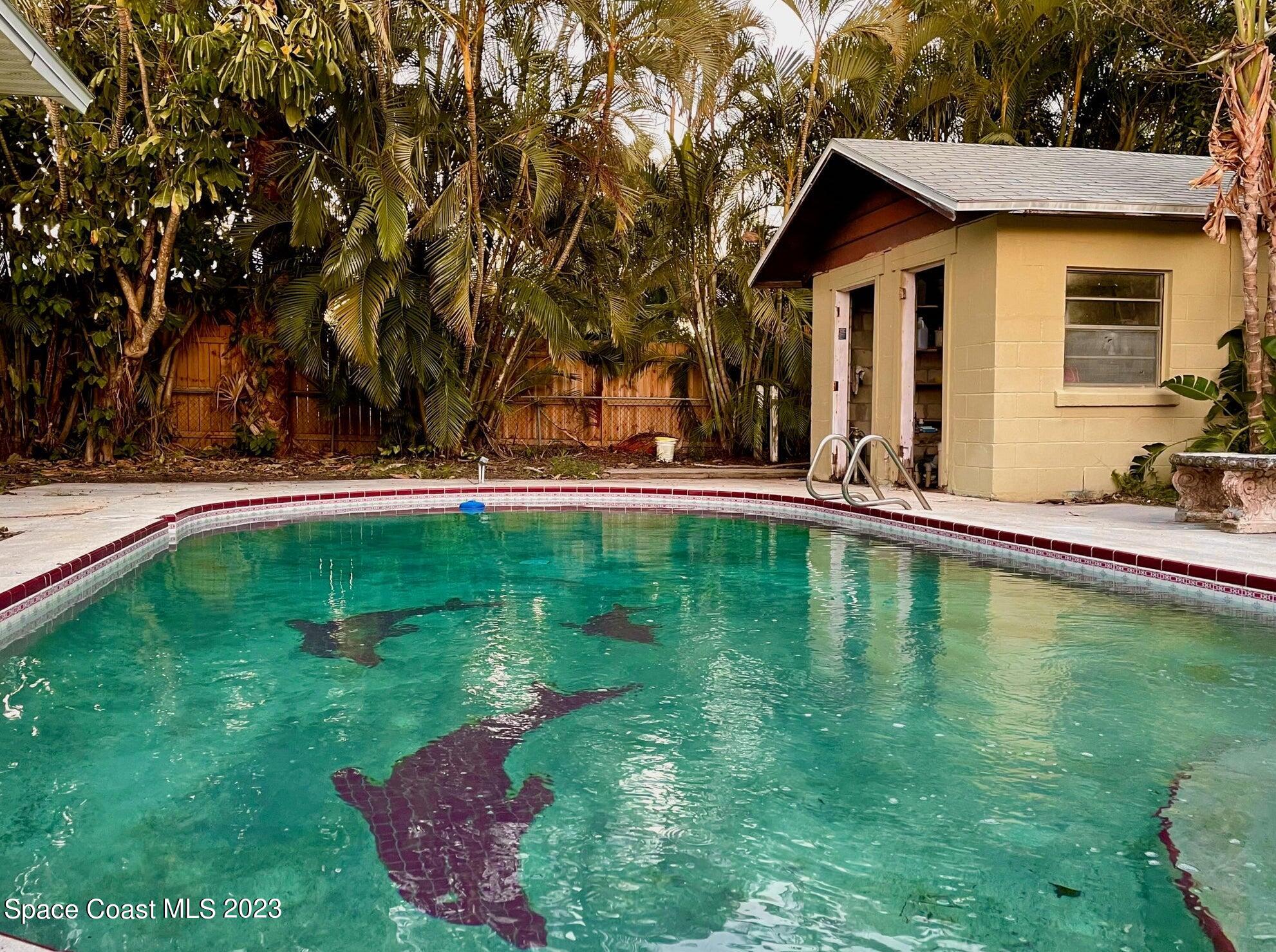 245 Richards Road Melbourne Beach, FL 32951 - Photo 9 of 18 a view of a house with a yard patio and swimming pool