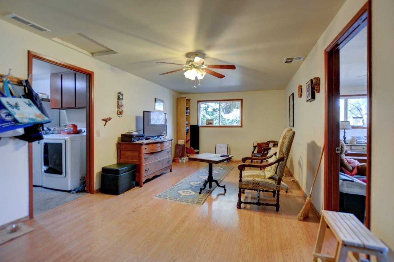 8684 Wagner Creek Road Talent, OR 97540 - Photo 69 of 78 a living room with furniture and a flat screen tv