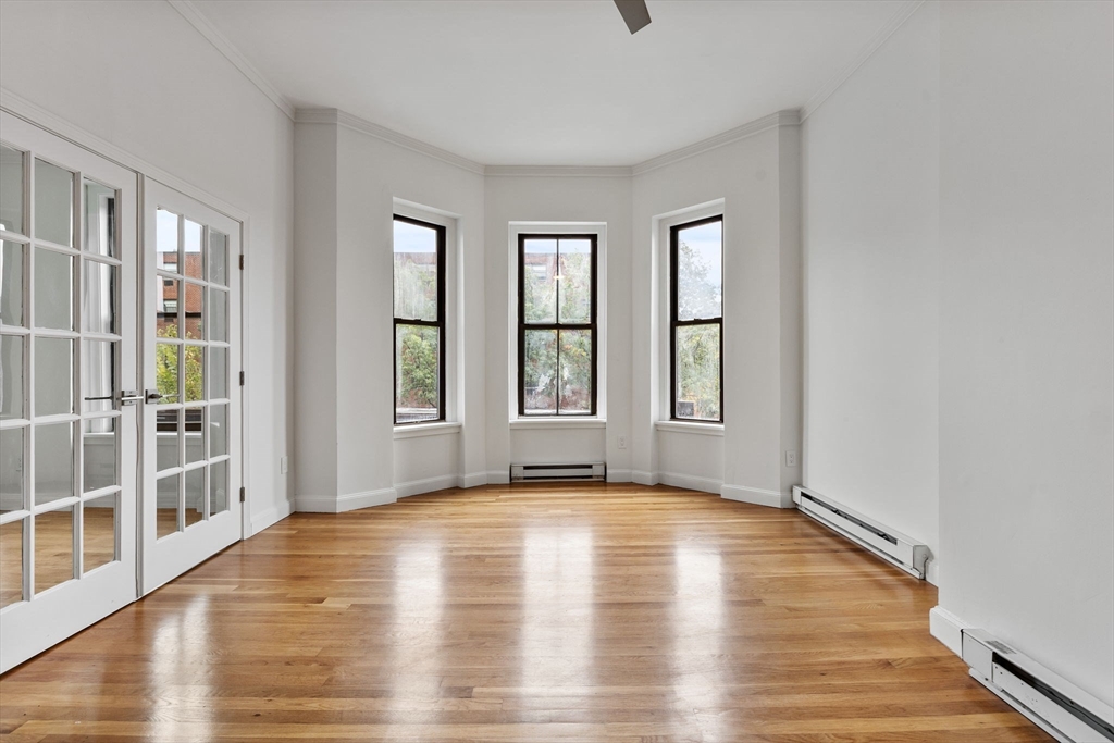 431 Columbus Avenue, Unit 4 Boston, MA 02116 - Photo 1 of 27 a view of an empty room with wooden floor and a window