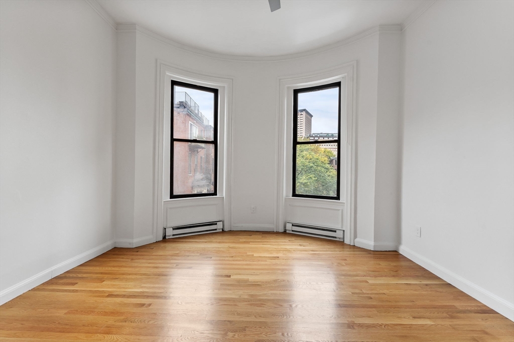 431 Columbus Avenue, Unit 4 Boston, MA 02116 - Photo 13 of 27 a view of empty room with window and wooden floor