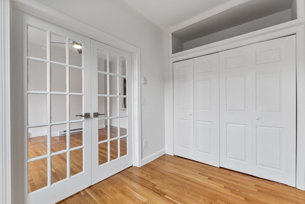 431 Columbus Avenue, Unit 4 Boston, MA 02116 - Photo 6 of 27 a view of an empty room with wooden floor and a window