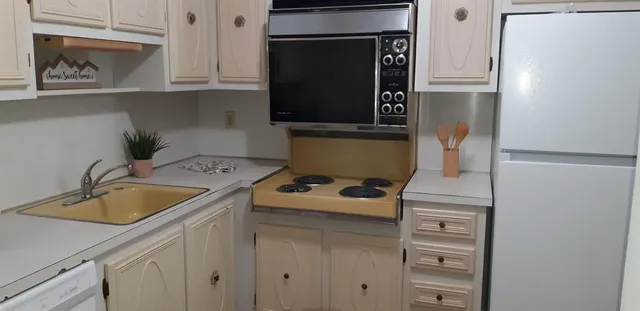 a kitchen with a sink and a stove top oven