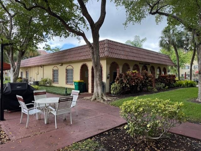 259 South Cypress Road, Unit 528 Pompano Beach, FL 33060 - Photo 9 of 10 a view of a patio with table and chairs and potted plants