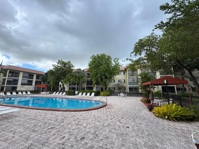 a swimming pool with outdoor seating yard and barbeque oven