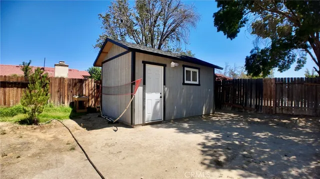 a living room with lots of furniture and a refrigerator