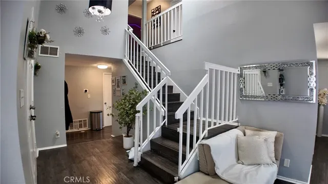 a view of entryway and hall with wooden floor