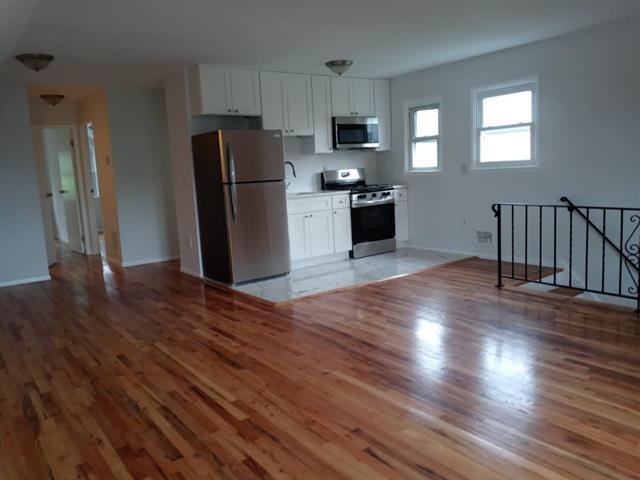 2 Pinecrest Road, Unit 2 Jersey City, NJ 07305 - Photo 3 of 7 a kitchen with stainless steel appliances granite countertop a refrigerator microwave and stove