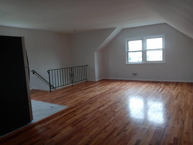 2 Pinecrest Road, Unit 2 Jersey City, NJ 07305 - Photo 4 of 7 a view of an empty room with wooden floor and a window