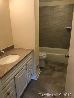 2808 Studley Road Charlotte, NC 28212 - Photo 3 of 6 a bathroom with a granite countertop sink toilet and shower