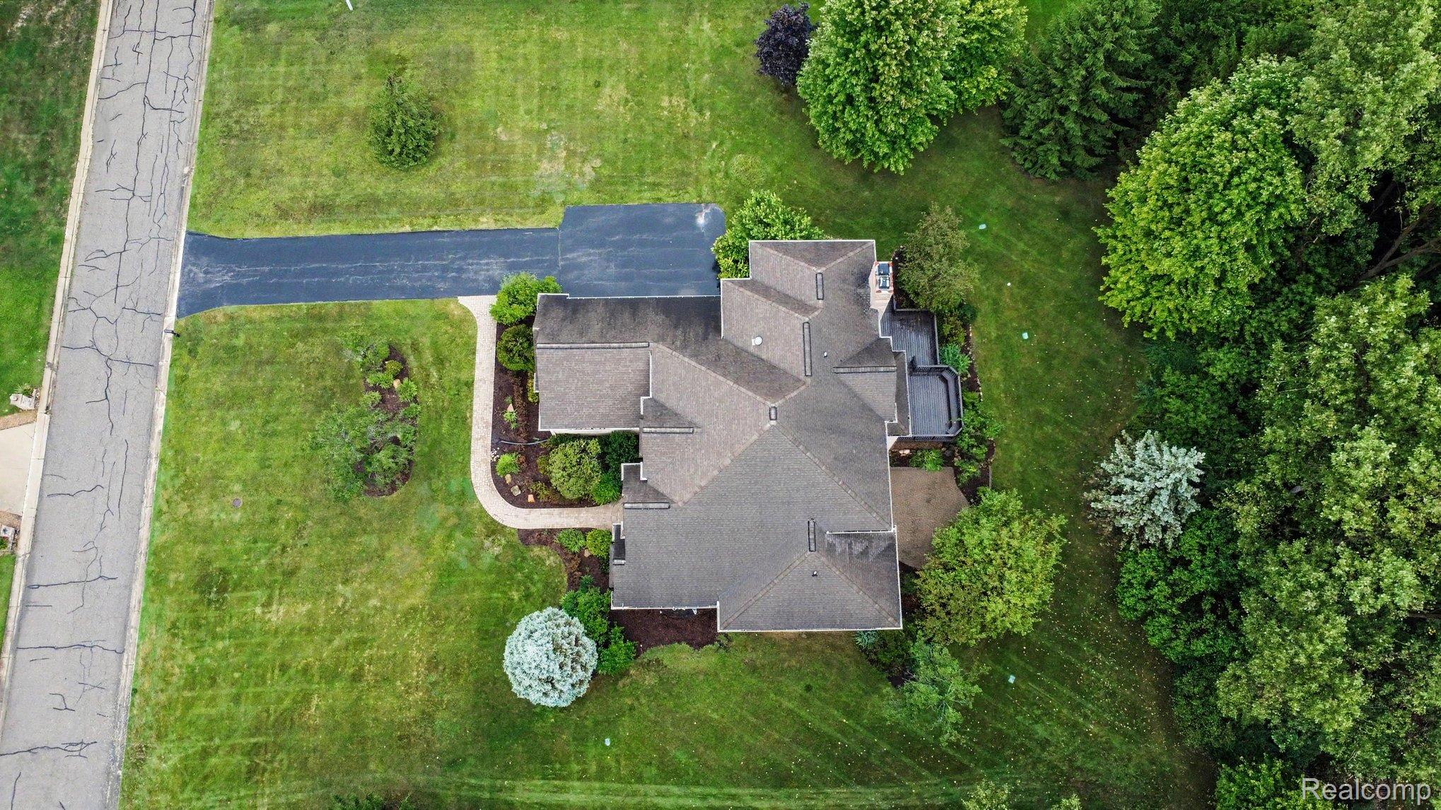 4875 Green Meadow Lane Rochester, MI 48306 - Photo 53 of 60 Expansive green space featuring mature trees and established landscaping