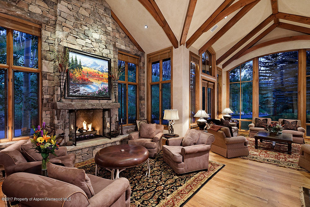 80 Spruce Ridge Lane Snowmass Village, CO 81615 - Photo 11 of 40 a living room with furniture fireplace and a large window