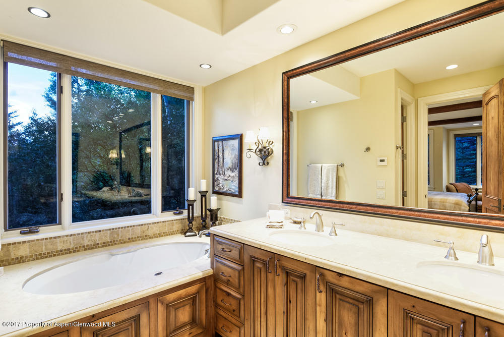 80 Spruce Ridge Lane Snowmass Village, CO 81615 - Photo 27 of 40 a bathroom with a sink and a large mirror