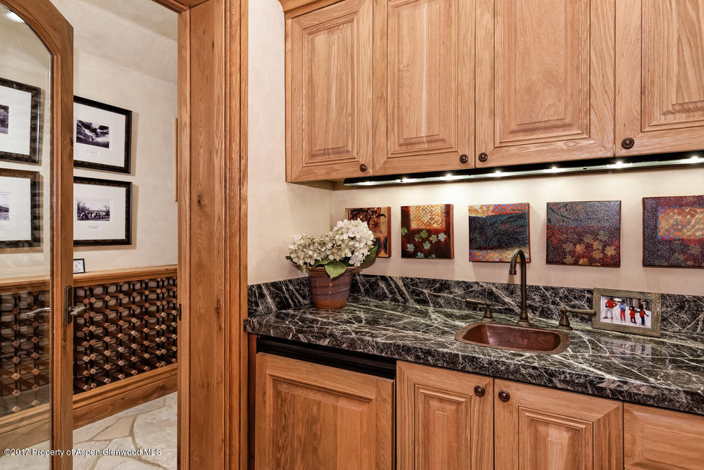 80 Spruce Ridge Lane Snowmass Village, CO 81615 - Photo 31 of 40 a kitchen with granite countertop a sink and cabinets