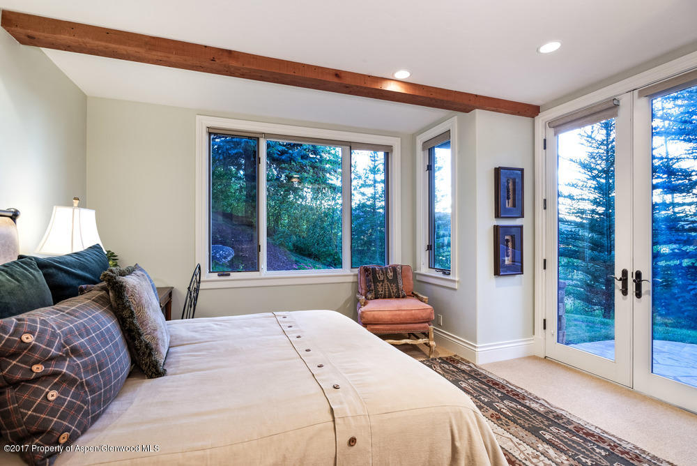80 Spruce Ridge Lane Snowmass Village, CO 81615 - Photo 34 of 40 a bedroom with a large bed and a large window