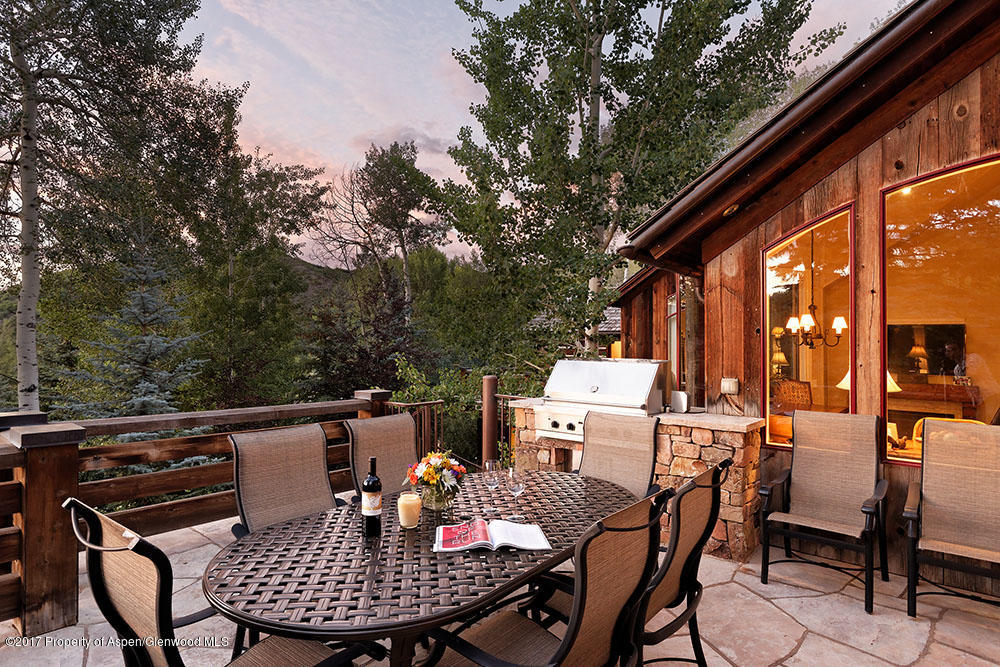 80 Spruce Ridge Lane Snowmass Village, CO 81615 - Photo 5 of 40 a view of a patio with a table and chairs