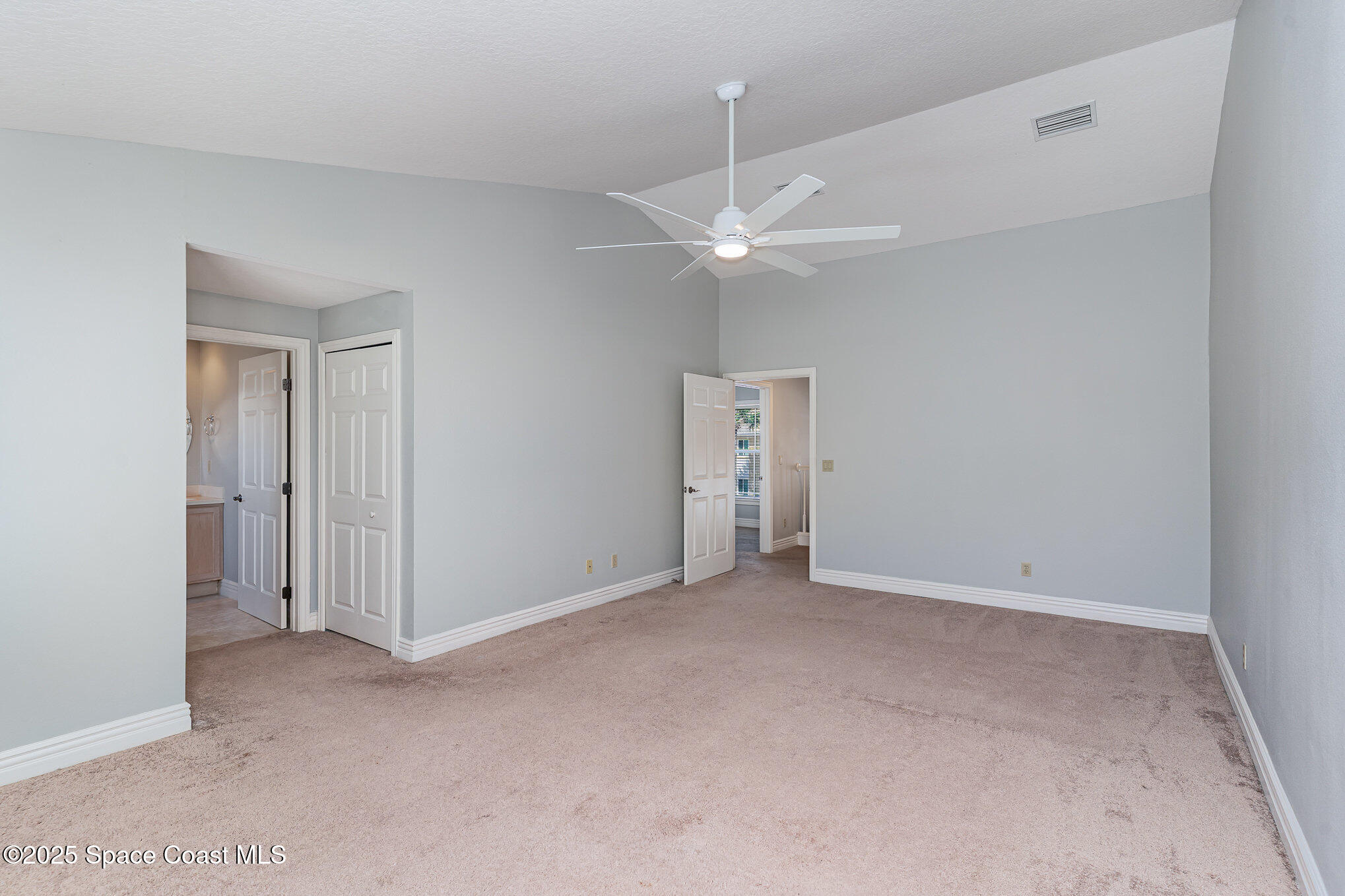 609 Cedar Side Circle Northeast Palm Bay, FL 32905 - Photo 11 of 19 an empty room with a ceiling fan and a window