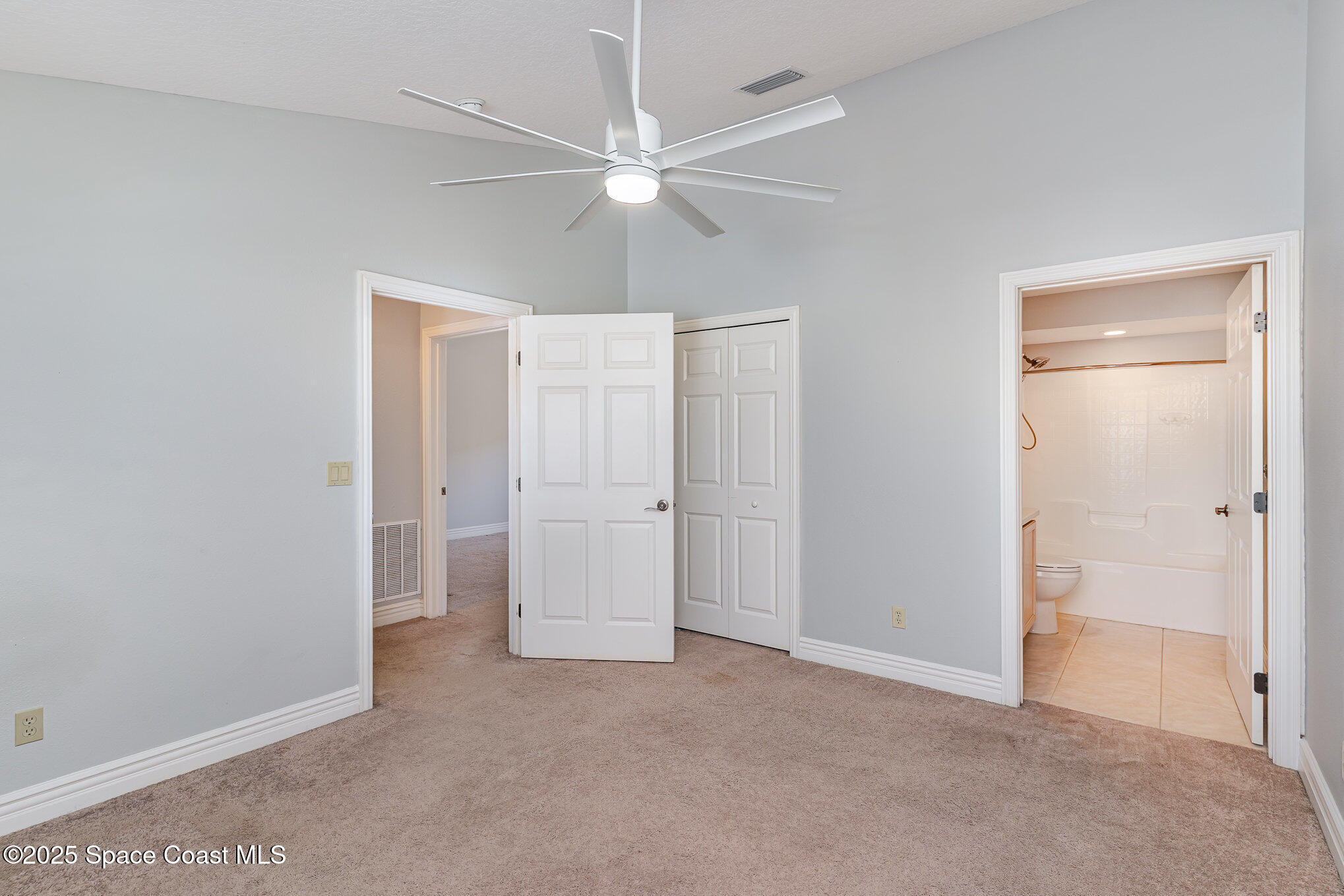 609 Cedar Side Circle Northeast Palm Bay, FL 32905 - Photo 14 of 19 a view of a room with closet and fan