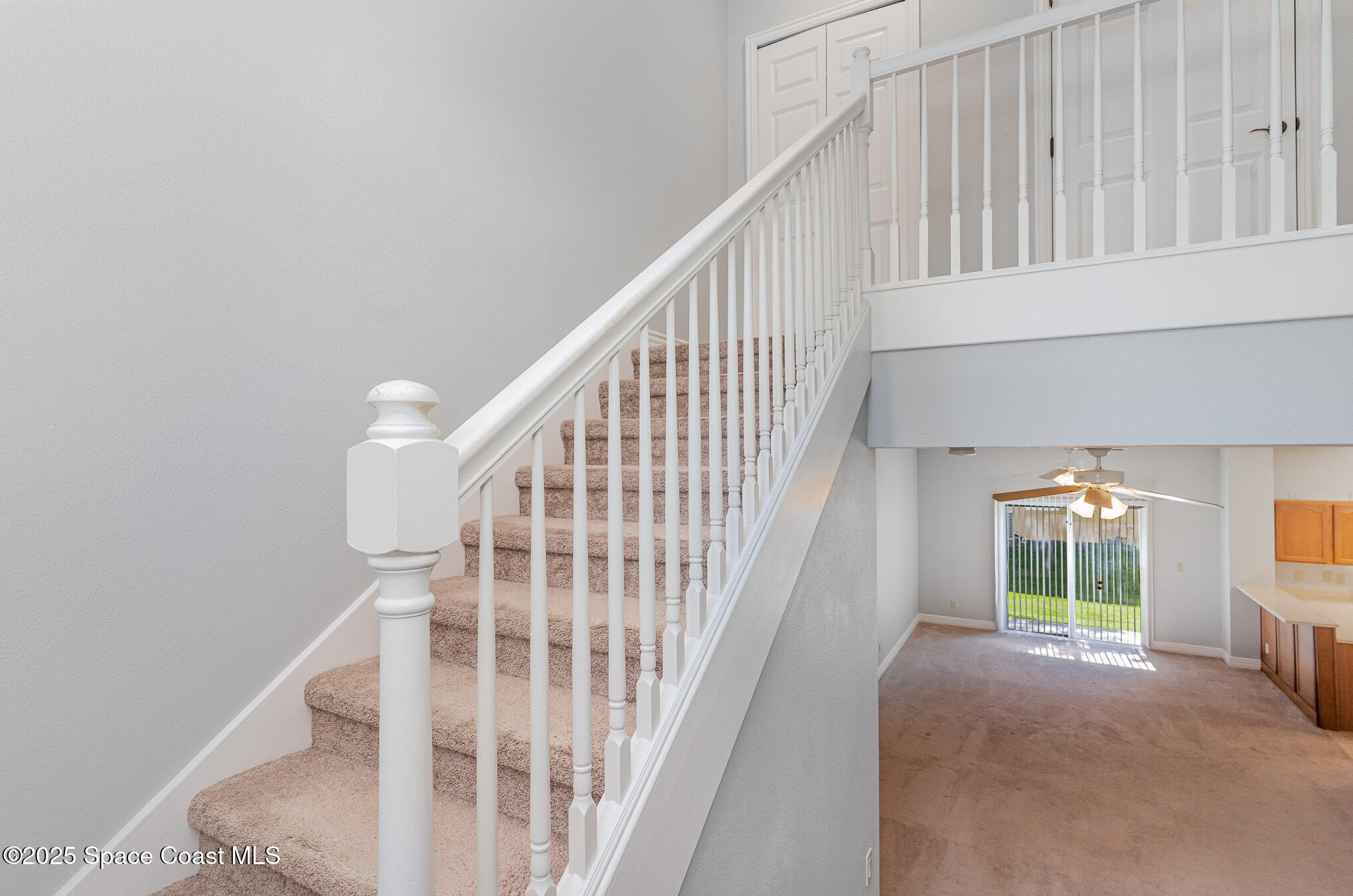 609 Cedar Side Circle Northeast Palm Bay, FL 32905 - Photo 2 of 19 a view of staircase with railing and white walls