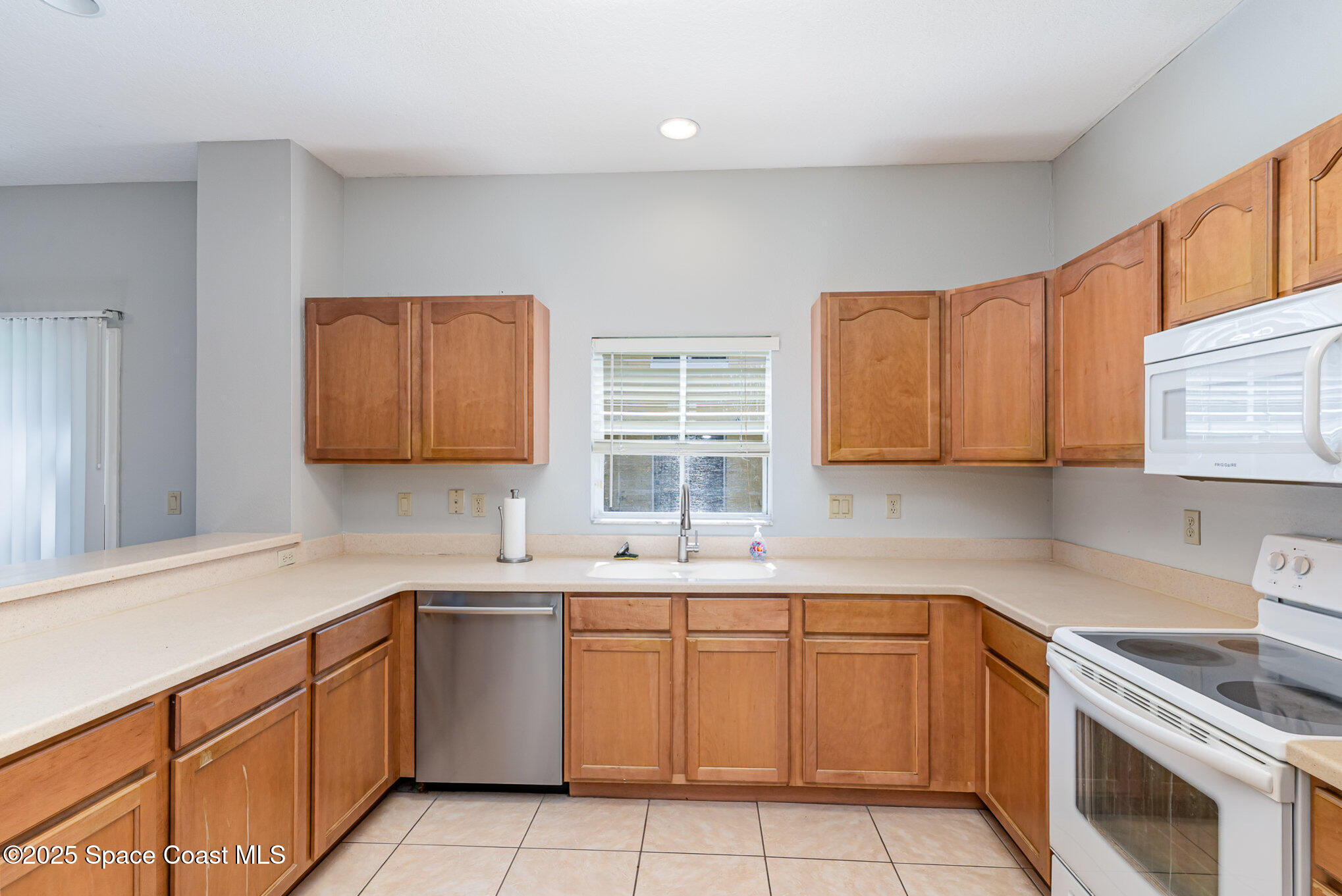 609 Cedar Side Circle Northeast Palm Bay, FL 32905 - Photo 6 of 19 a kitchen with a sink stove top oven and cabinets