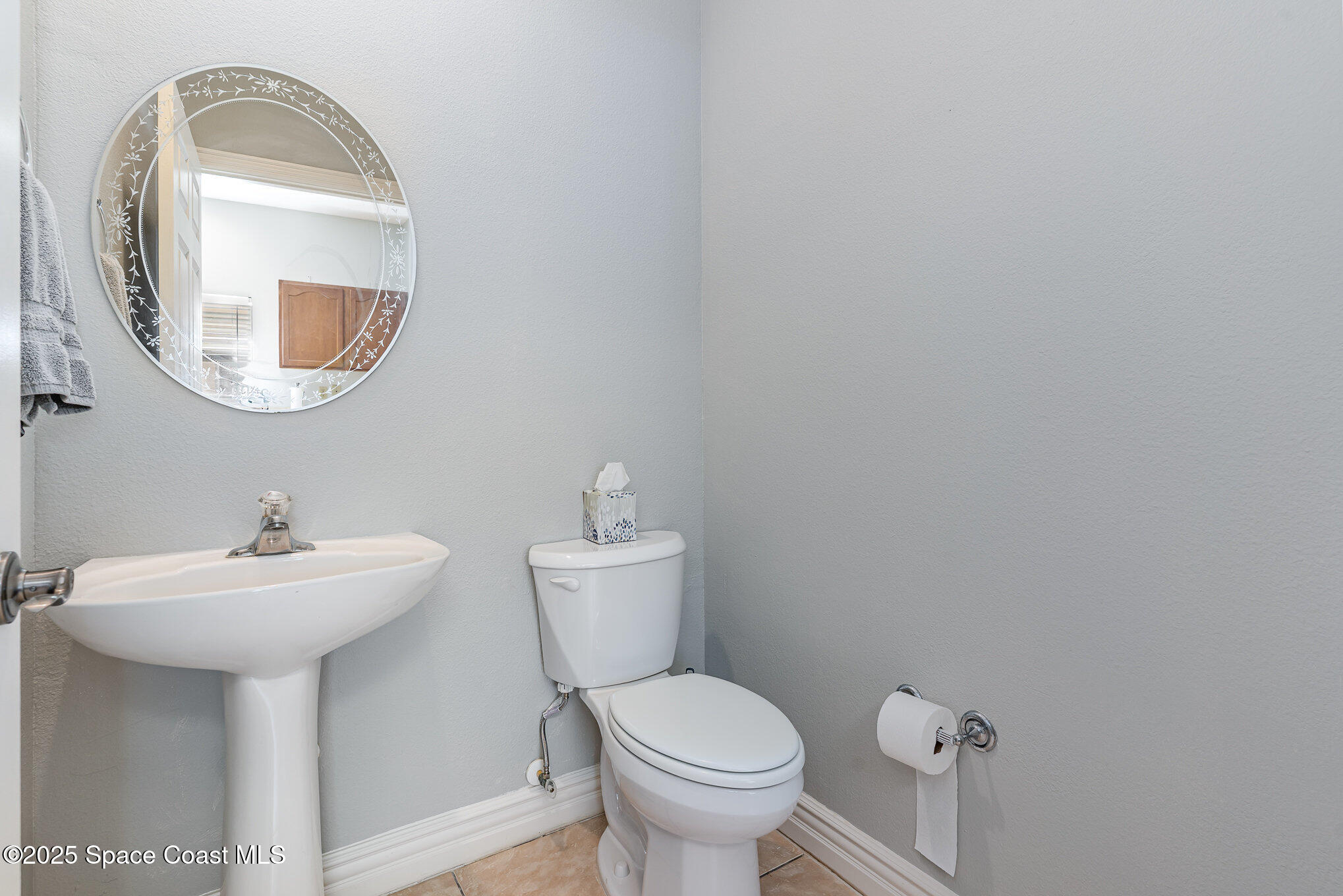 609 Cedar Side Circle Northeast Palm Bay, FL 32905 - Photo 8 of 19 a bathroom with a sink mirror and toilet